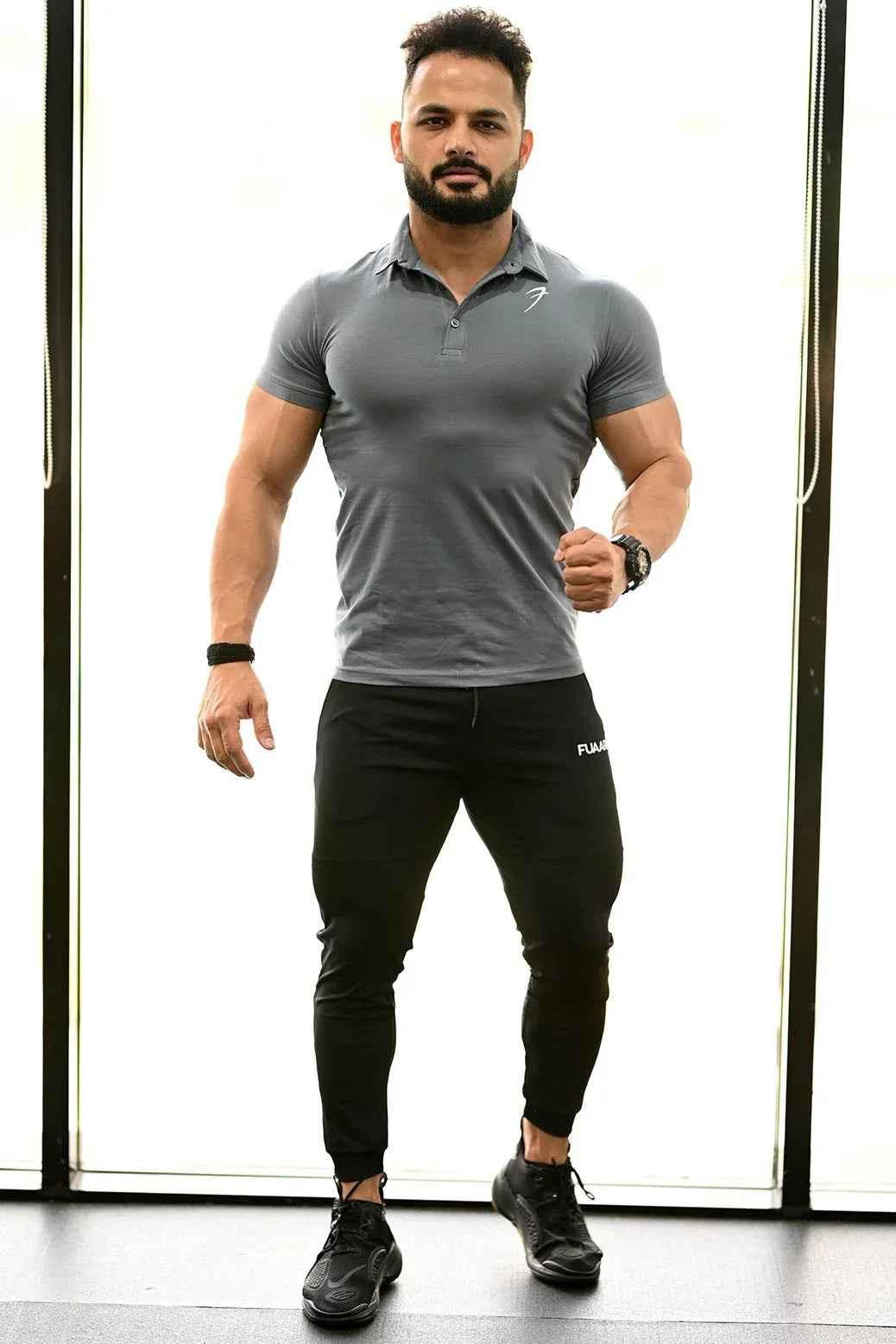 Grey Polo T-shirt from Fuaark Nz featuring a classic collar and short sleeves, displayed on a plain background.