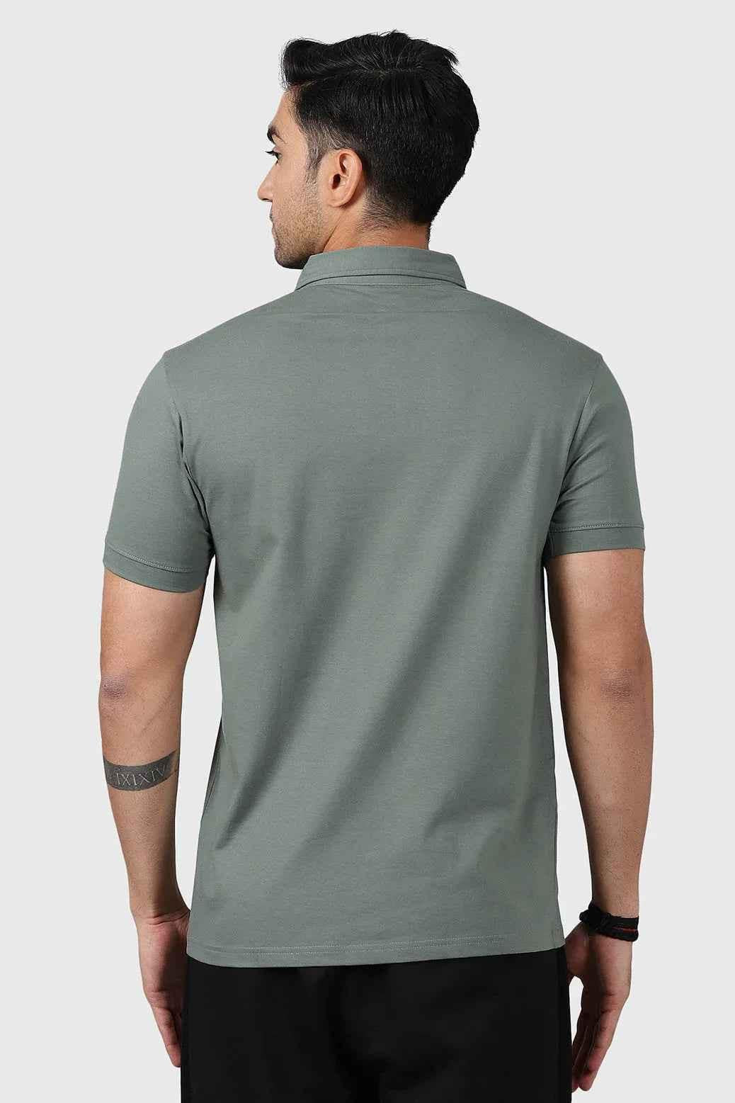 Sage green Polo T-shirt by Fuaark Nz, made of soft fabric, featuring a classic collar and short sleeves.