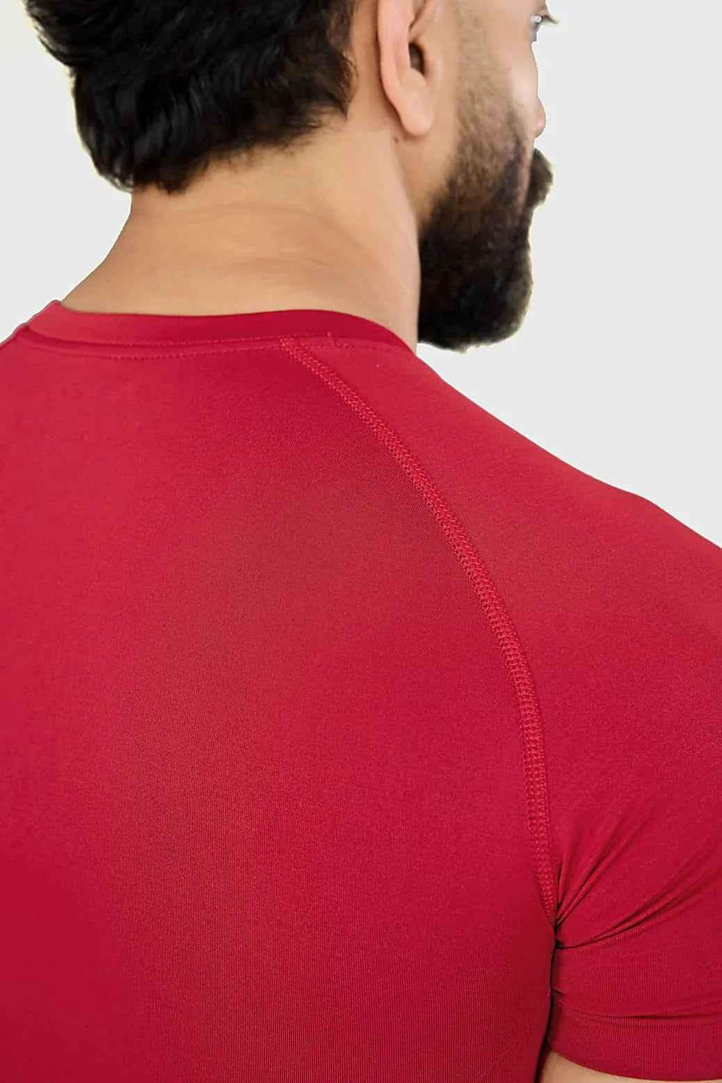 Red Fuaark Nz Power Seamless T-shirt shown on a model, highlighting its fitted design and smooth fabric.