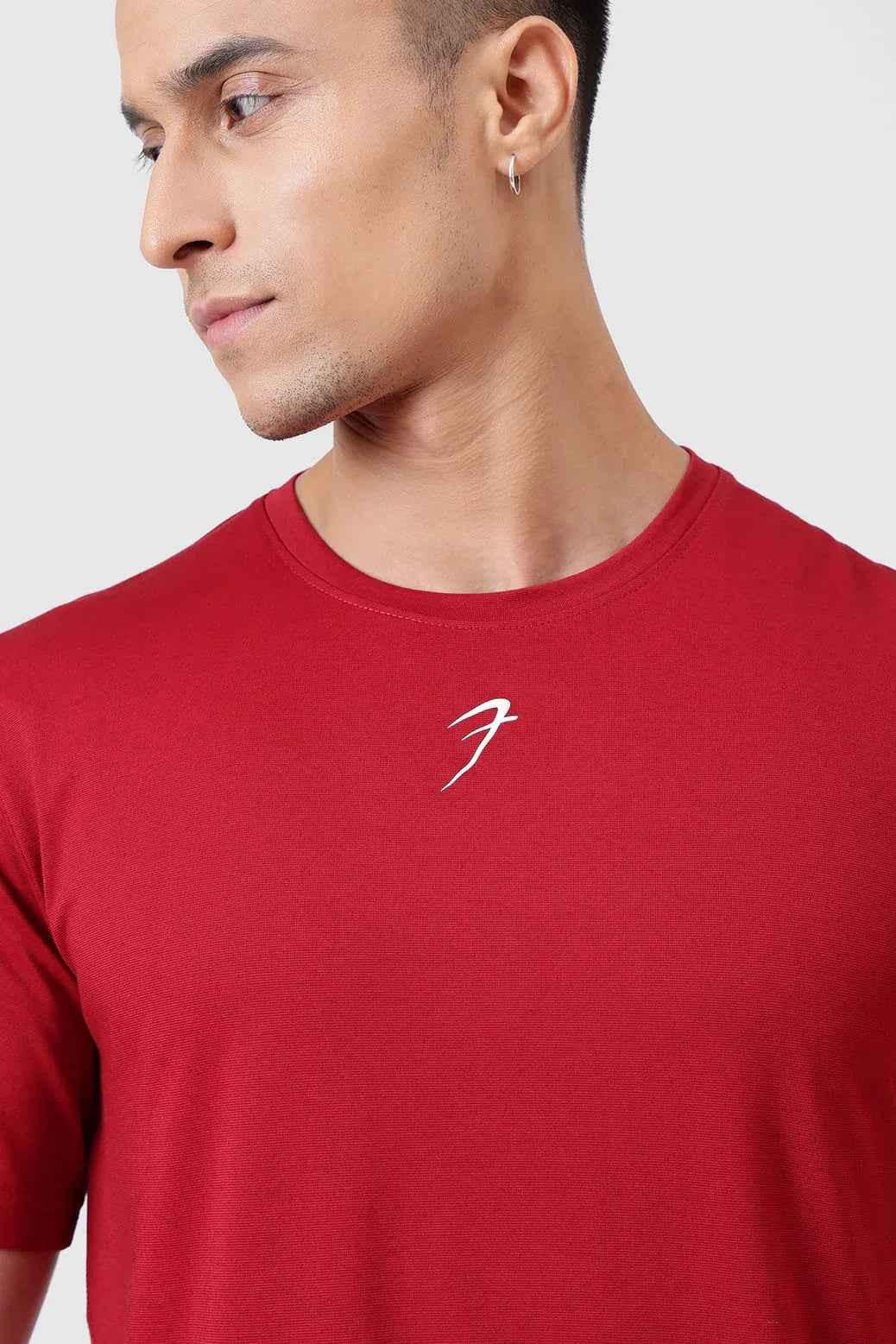 Deep red Fuaark Nz running T-shirt with breathable fabric, designed for comfort and performance during exercise.