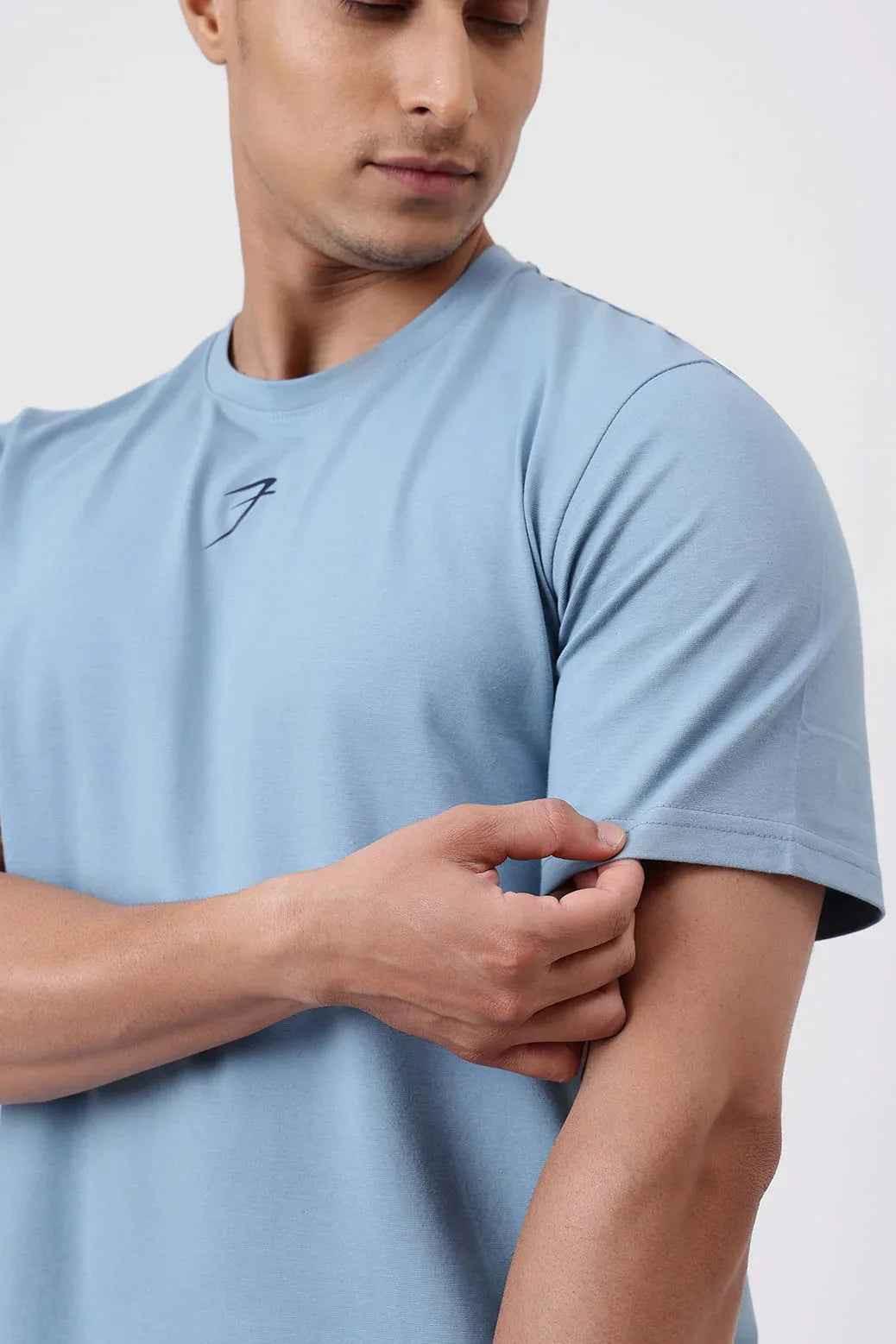 Light blue Pulse Running T-shirt by Fuaark Nz, made of breathable fabric, shown on a hanger.
