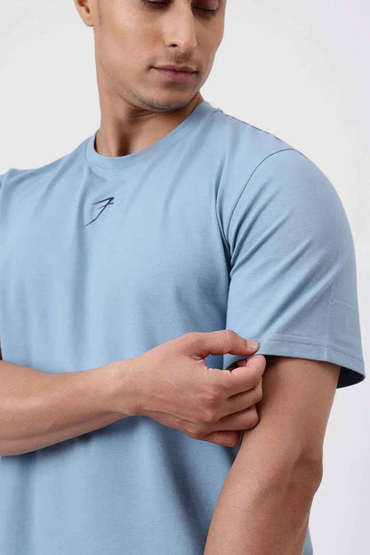 Light blue Pulse Running T-shirt by Fuaark Nz, made of breathable fabric, shown on a hanger.