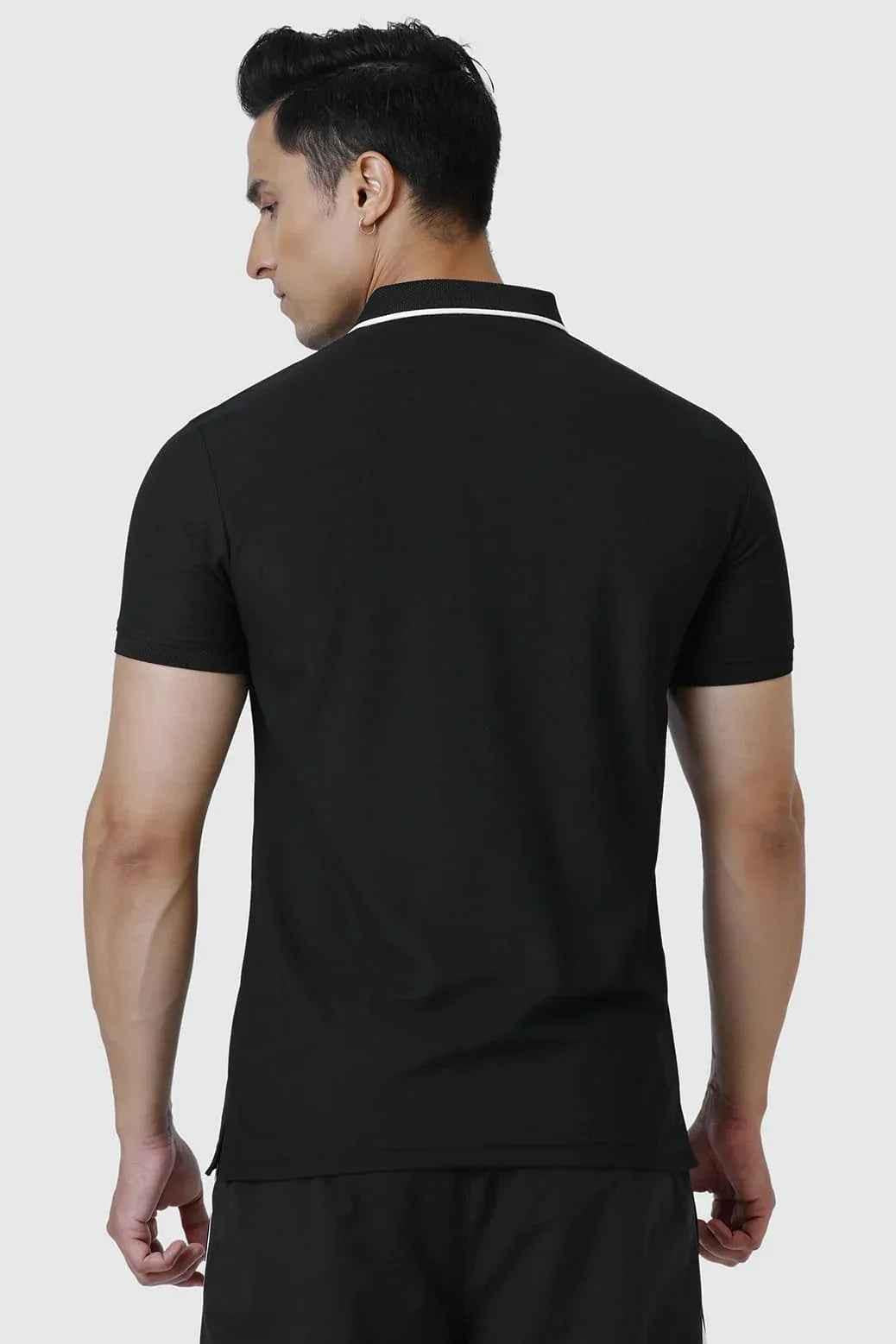 Black Fuaark Nz Stride Polo T-shirt displayed on a model, featuring a classic polo collar and short sleeves.