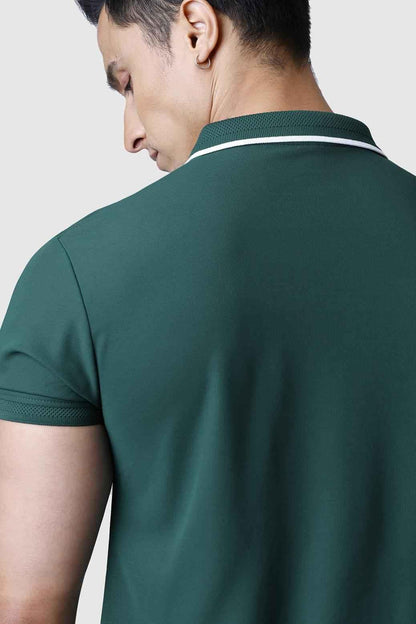 Green Fuaark Nz Stride Polo T-shirt laid flat, showing neckline and logo detail, made from comfortable cotton fabric.