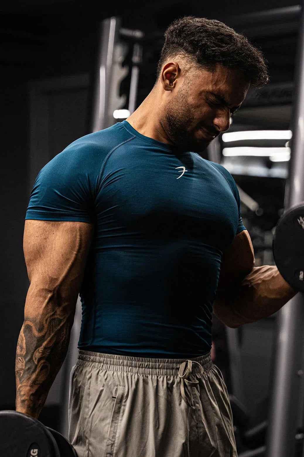 Fuaark Nz teal men's compression T-shirt designed for enhanced workout performance and athletic comfort.