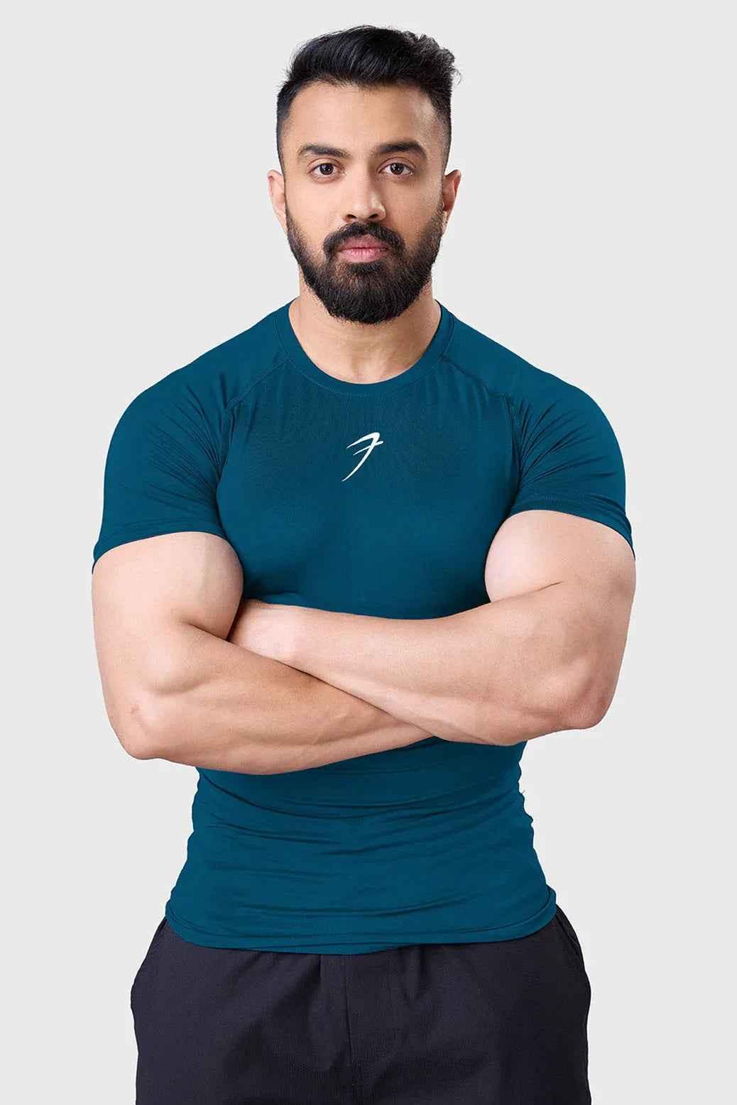 Teal compression T-shirt for men by Fuaark Nz, designed to enhance workout performance and provide a snug, supportive fit.