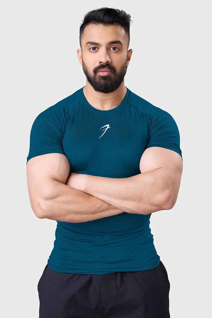 Teal compression T-shirt for men by Fuaark Nz, designed to enhance workout performance and provide a snug, supportive fit.