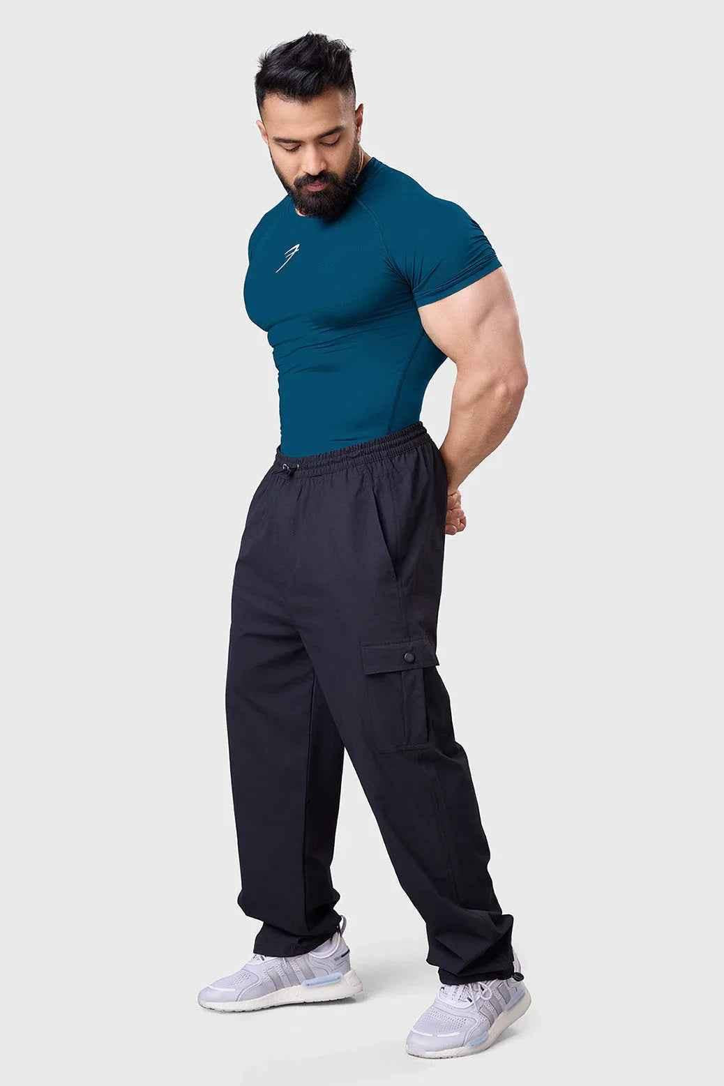 Teal compression T-shirt for men by Fuaark Nz, designed to enhance workout performance and provide a snug fit during exercise.