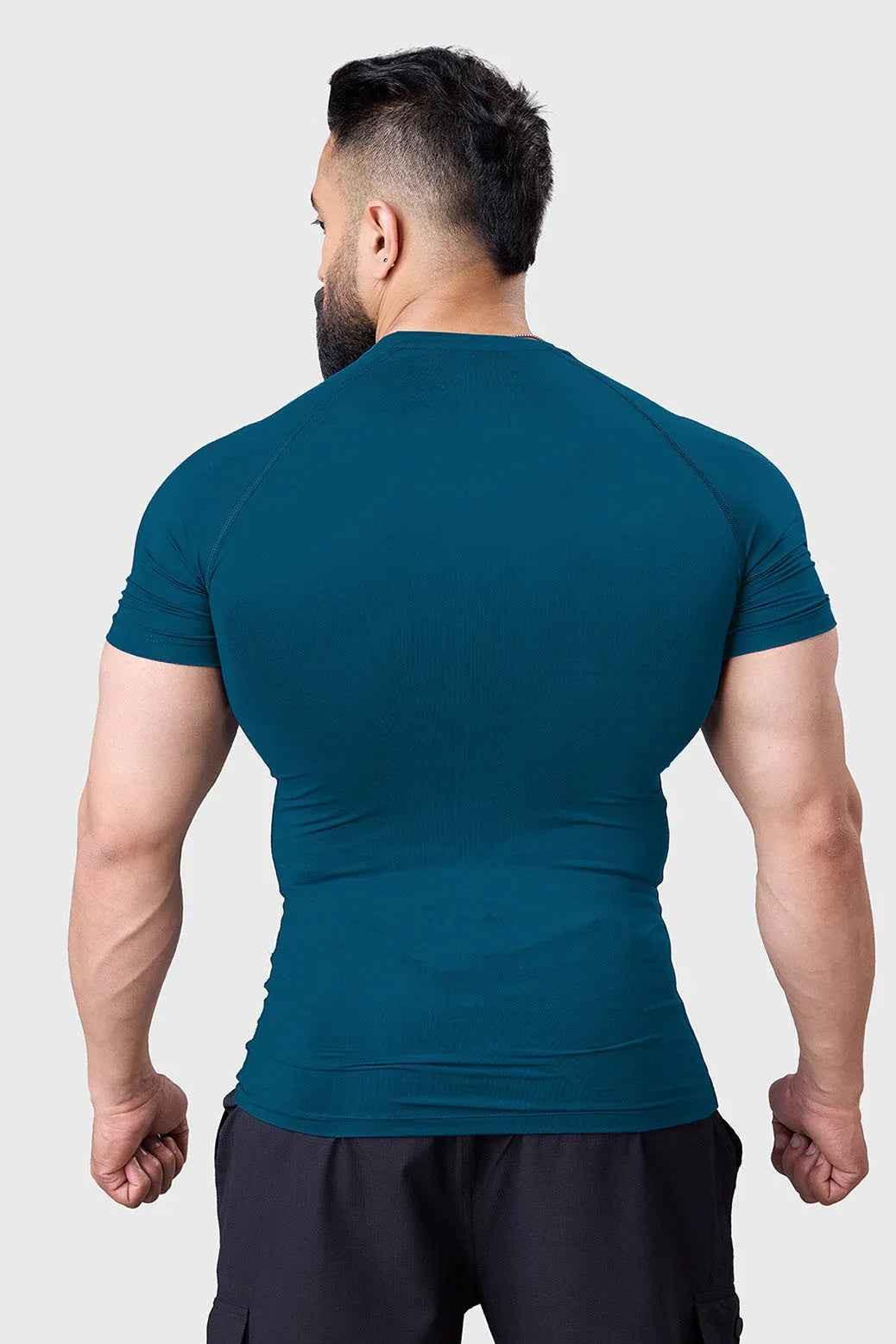 Teal compression T-shirt for men by Fuaark Nz, designed to enhance workout performance and provide a snug fit during exercise.