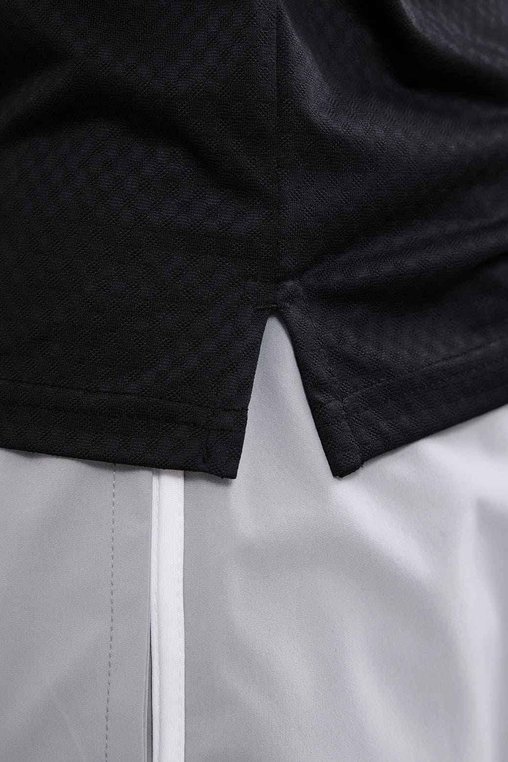 Black Wave Polo T-shirt by Fuaark NZ, showing a close-up of the stylish polo collar and fabric texture.