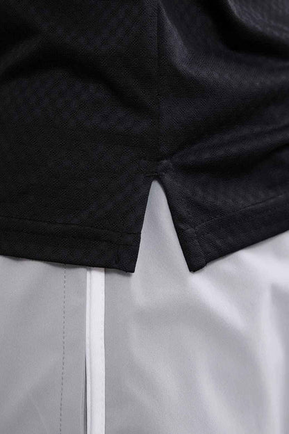 Black Wave Polo T-shirt by Fuaark NZ, showing a close-up of the stylish polo collar and fabric texture.
