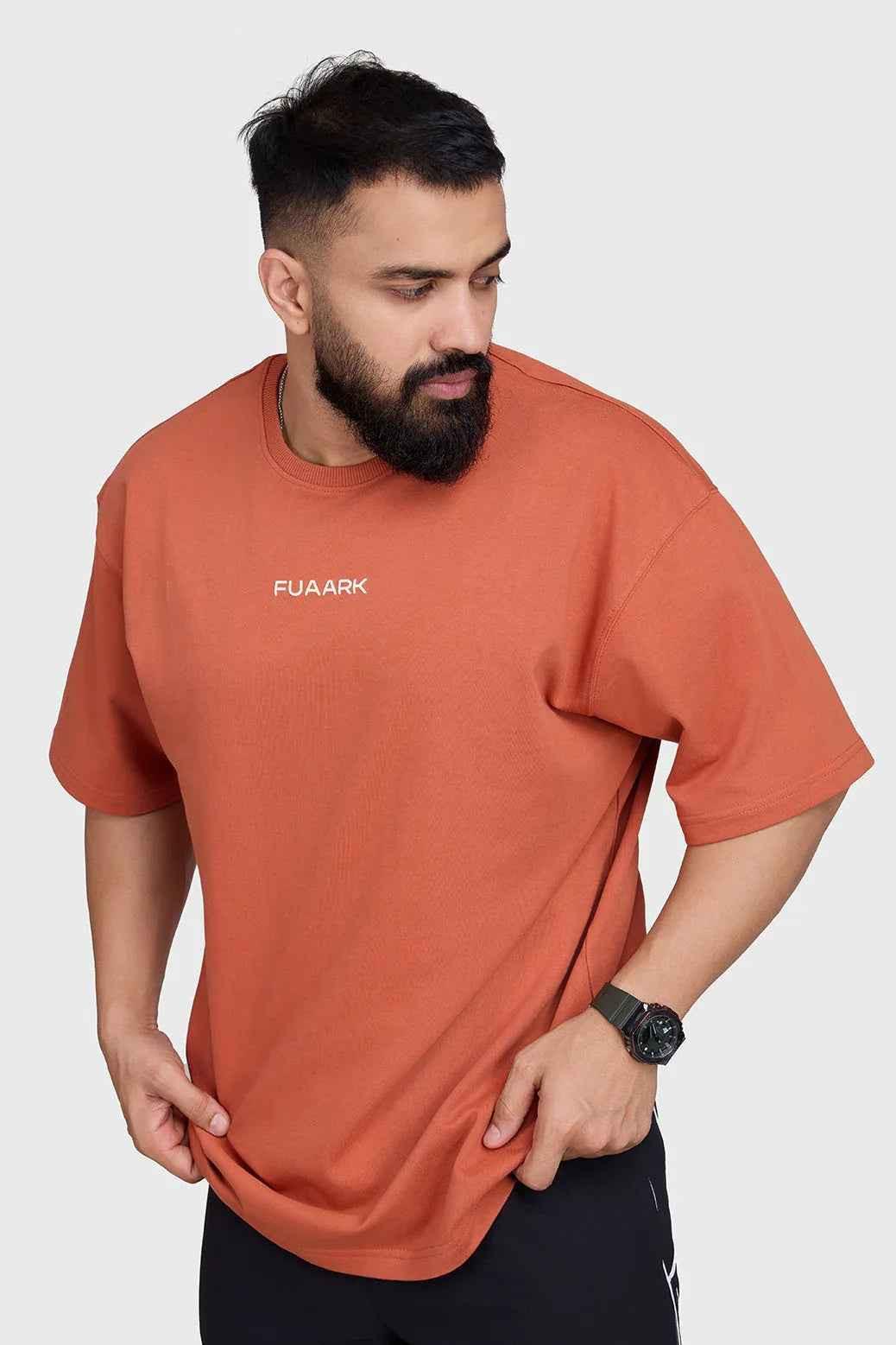 Rust-colored oversized T-shirt by Fuaark Nz, featuring a relaxed fit and comfortable fabric for casual style.