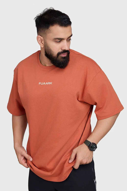 Rust-colored oversized T-shirt by Fuaark Nz, featuring a relaxed fit and comfortable fabric for casual style.