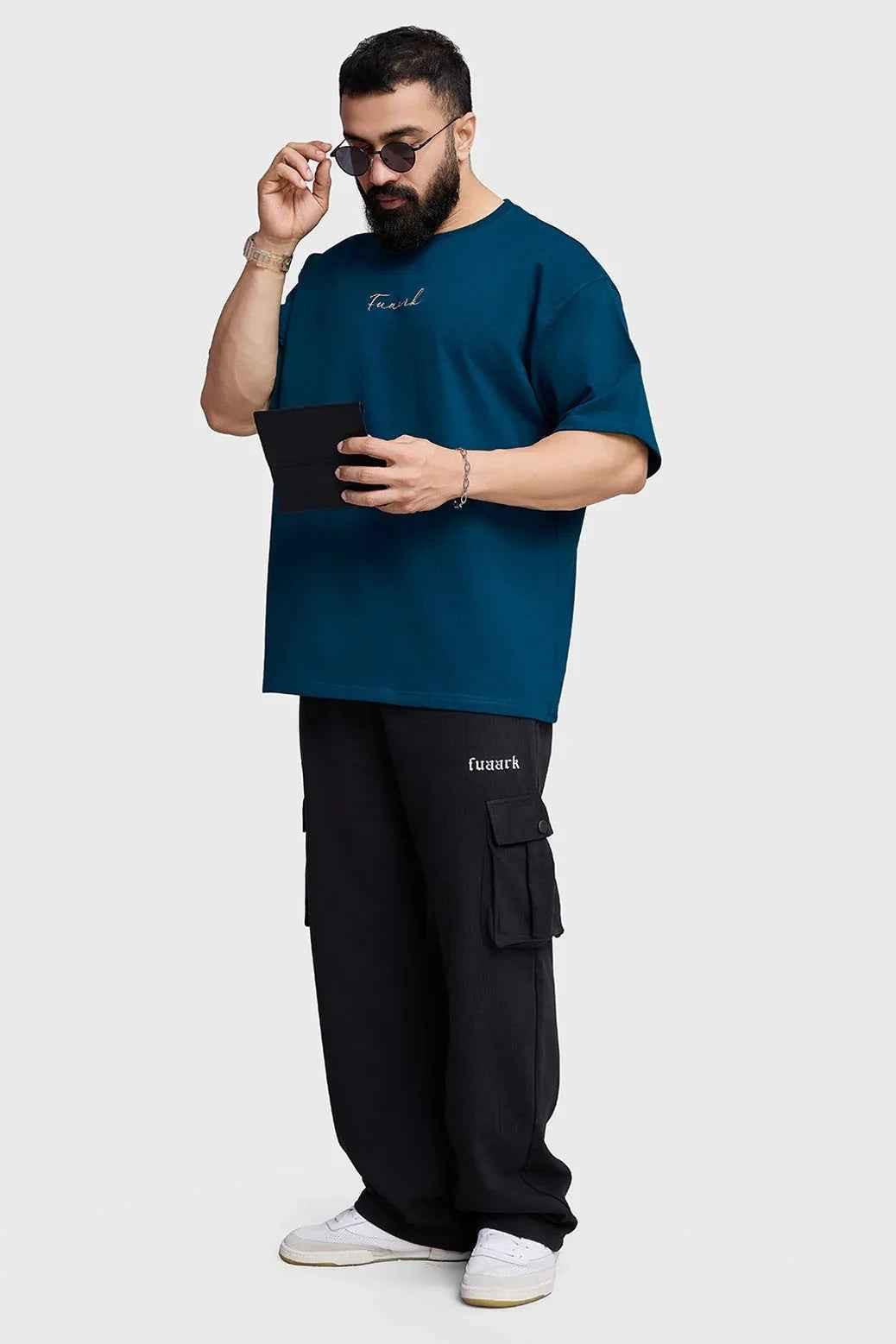 Fuaark Nz bold teal oversized T-shirt for women, relaxed fit, soft fabric, casual style, displayed on a plain background.