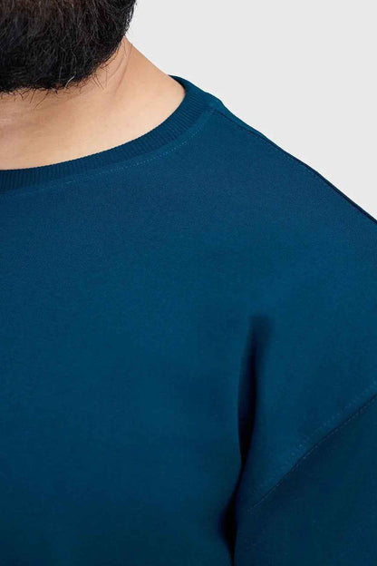 Fuaark Nz bold teal oversized T-shirt for women, casual fit, soft fabric, and stylish design, displayed on a plain background.