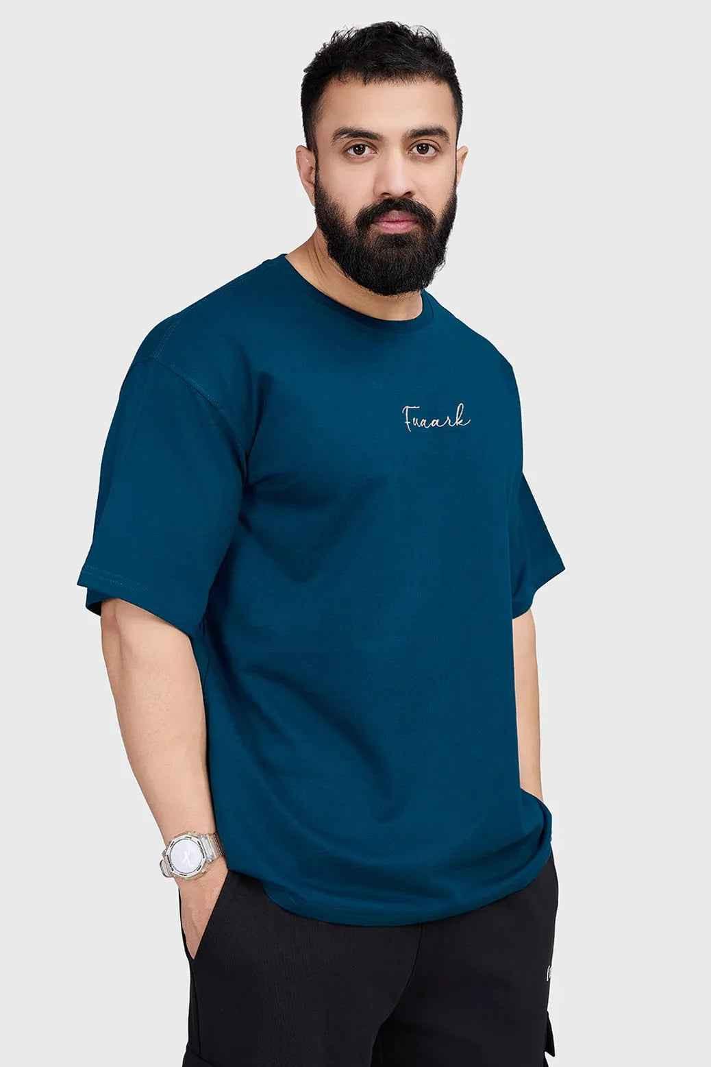 Fuaark Nz bold teal oversized T-shirt for women, relaxed fit, soft fabric, stylish casual wear, displayed on a hanger.
