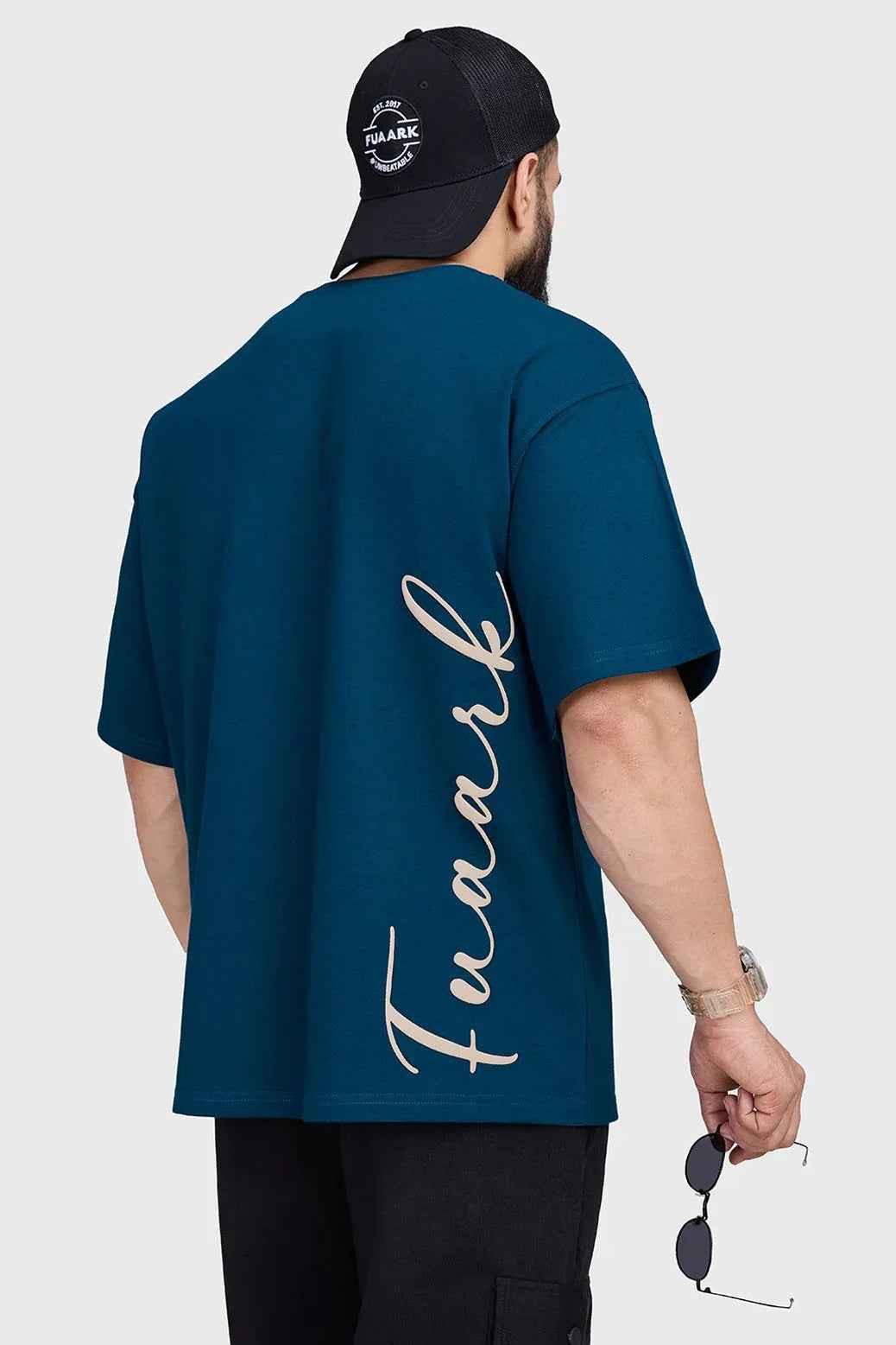 Fuaark Nz oversized teal T-shirt with bold style, relaxed fit, and soft fabric, shown on a model highlighting the trendy casual look.