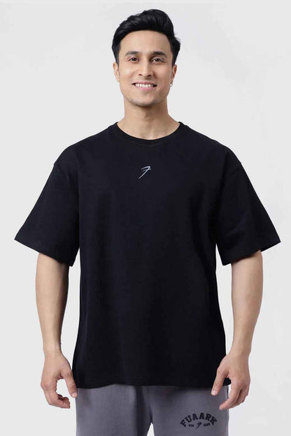 Black Fortitude oversized T-shirt by Fuaark Nz, showcasing a relaxed fit and casual style in the image.