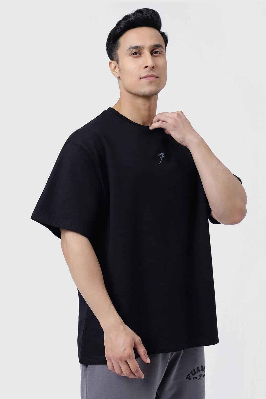 Black Fortitude Oversized T-shirt by Fuaark Nz, showcasing a relaxed fit and soft fabric on a plain background.