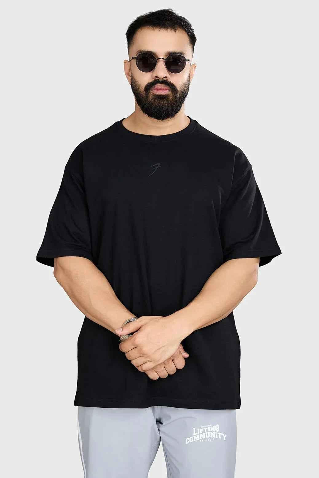 Black heavyweight oversized T-shirt by Fuaark Nz, showcasing a relaxed fit and comfortable style in a close-up view.