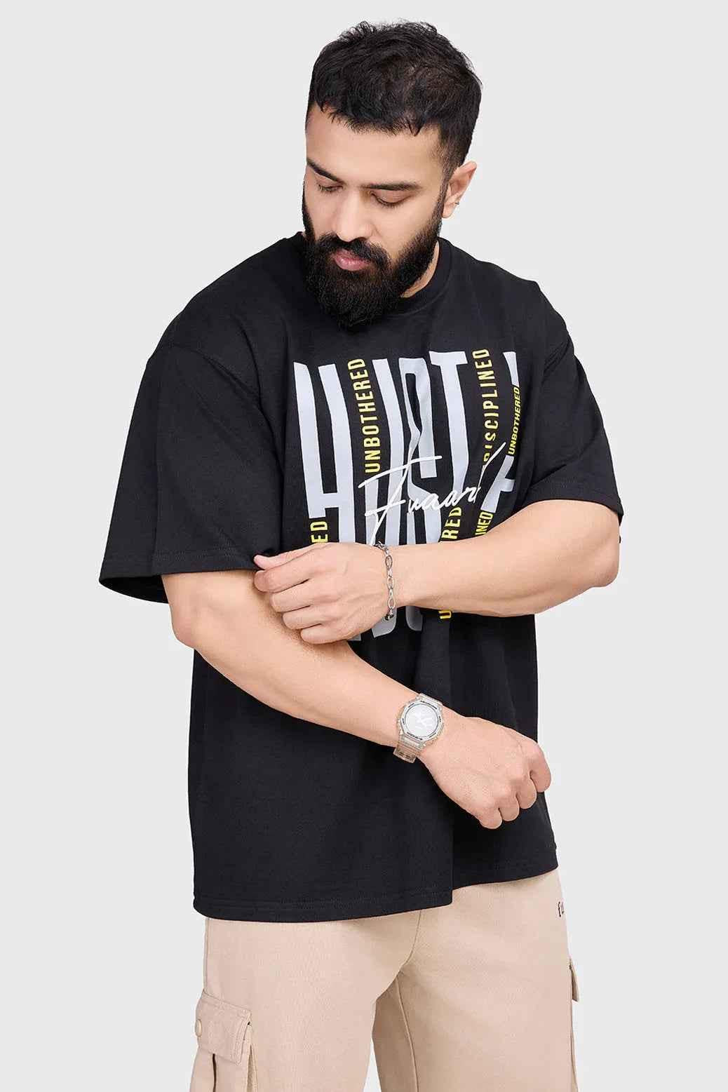 Black Hustle oversized T-shirt by Fuaark Nz, casual fit with bold graphic design, front view showing relaxed style.