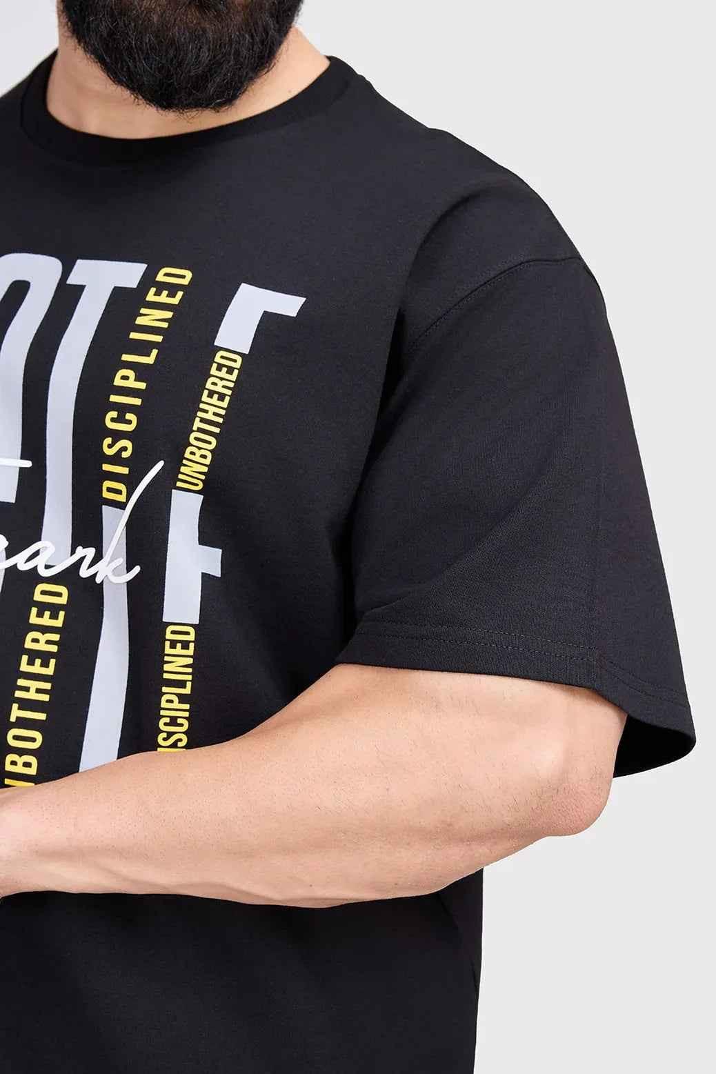Black Hustle oversized T-shirt by Fuaark Nz, showing the relaxed fit and classic crew neckline on a plain background.