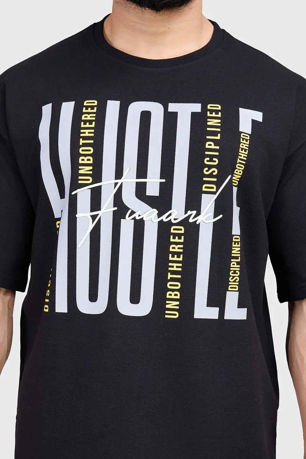 Black Hustle oversized T-shirt by Fuaark Nz, showing the relaxed fit and casual style on a model.