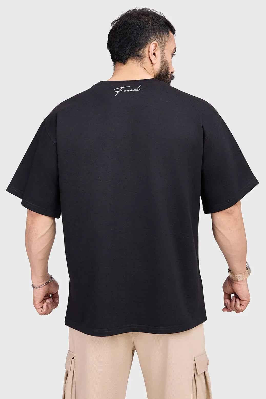 Black Hustle oversized T-shirt from Fuaark Nz, showing the relaxed fit and casual style on a plain background.