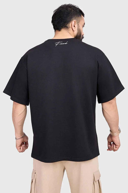 Black Hustle oversized T-shirt from Fuaark Nz, showing the relaxed fit and casual style on a plain background.