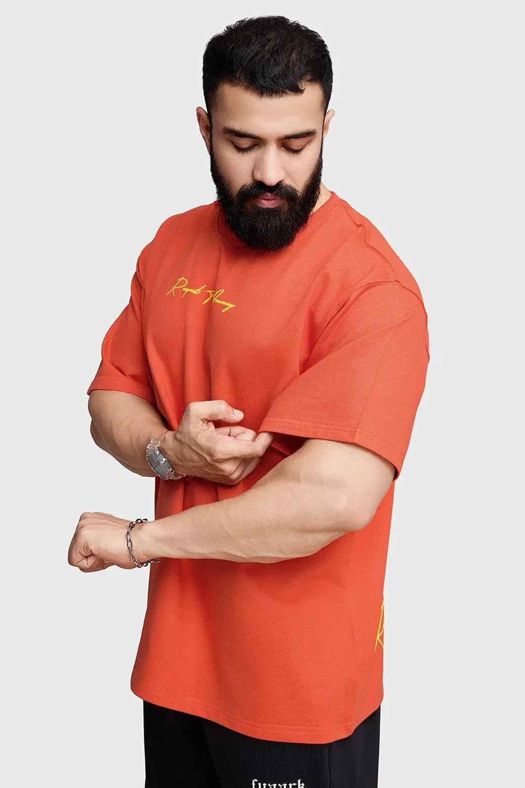 Orange oversized T-shirt from Fuaark Nz with "Respect The Journey" print, casual fit, and soft fabric, shown on a hanger.