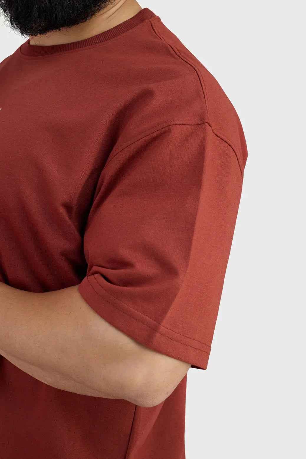 Rust-colored oversized T-shirt from Fuaark Nz, designed for ultimate comfort, shown in a casual fit on a model.