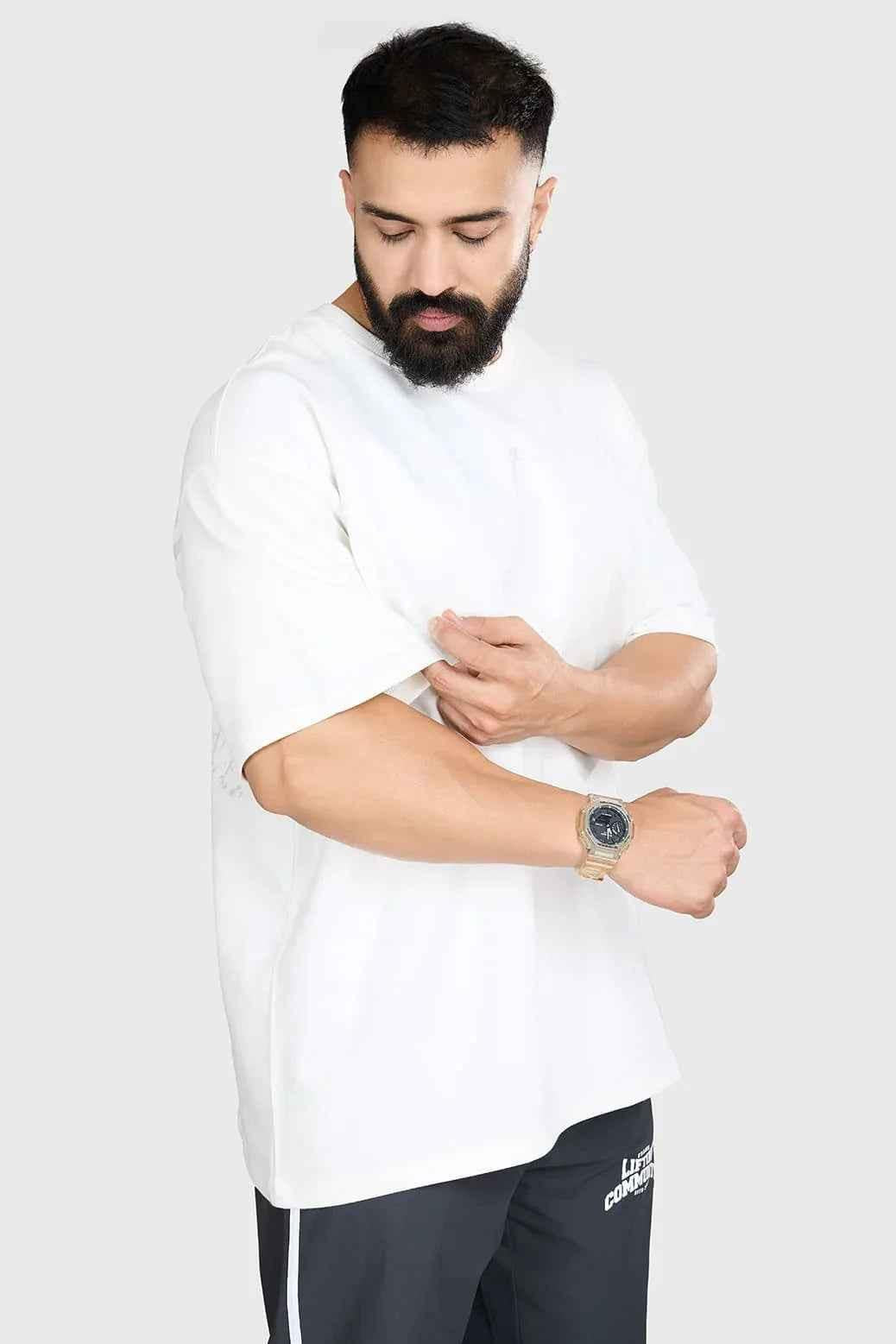 White heavyweight oversized T-shirt by Fuaark NZ, 100% cotton, relaxed streetwear fit, shown on a hanger.