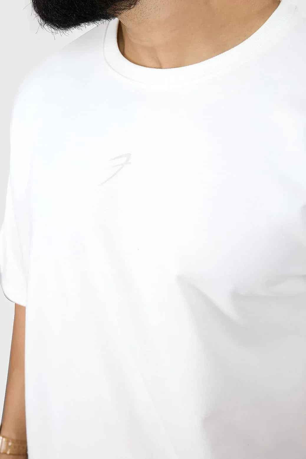 White heavyweight oversized cotton T-shirt by Fuaark NZ with a relaxed streetwear fit, shown in a close-up front view.