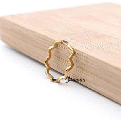 Glitters 18K gold plated stainless steel wavy women's ring showcasing a sleek, shiny design on a polished ring.