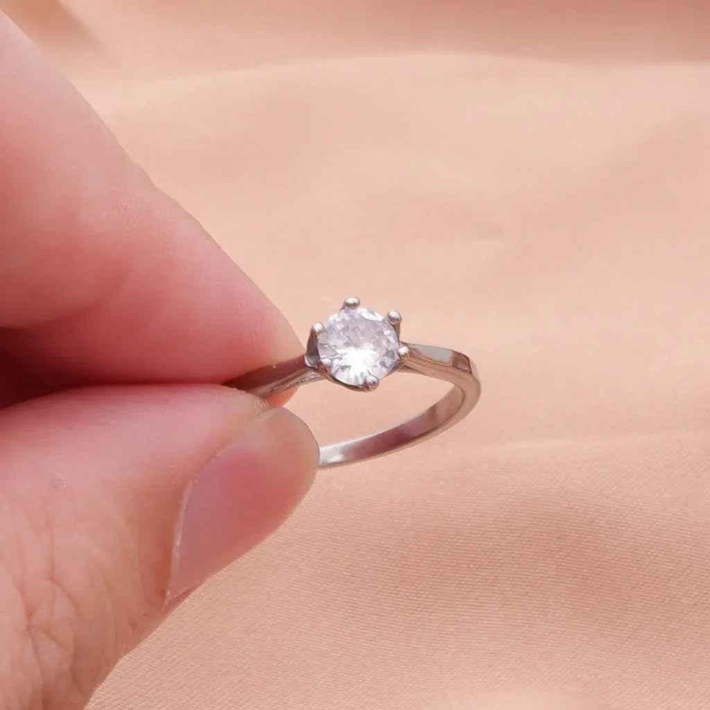 Sterling silver cubic zirconia wedding engagement ring from Glitters, featuring a sleek stainless steel band and sparkling stones.