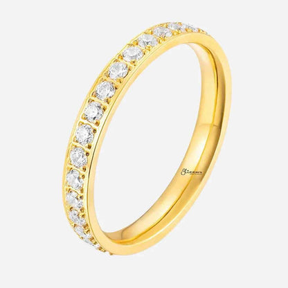 Gold stainless steel band ring with CZ inlay by Glitters, close-up of the fully inlayed design and polished finish.