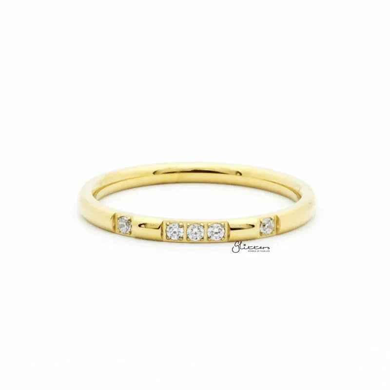 Gold stainless steel band ring with five CZ inlays, featuring a sleek design by Glitters.