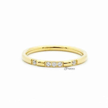 Gold stainless steel band ring with five CZ inlays, featuring a sleek design by Glitters.