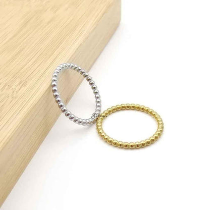 Silver stainless steel bead stacking ring by Glitters, showcasing a sleek, modern design with multiple small beads on a smooth band.