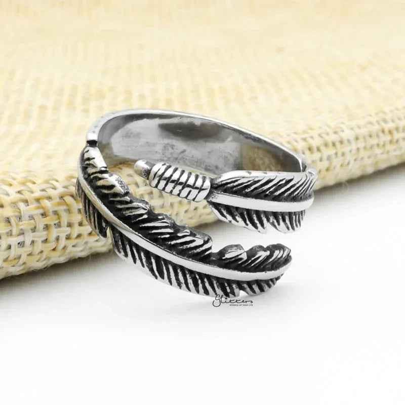Silver stainless steel feather ring by Glitters, featuring detailed feather design and smooth band for stylish wear.