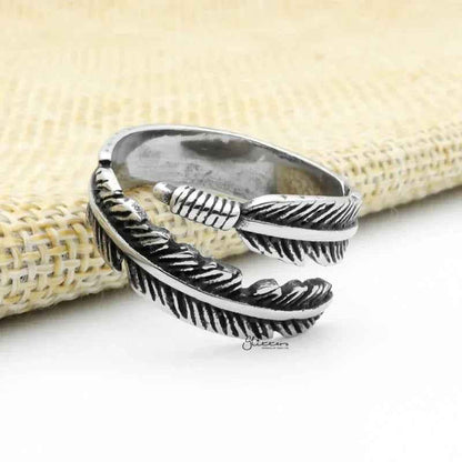 Silver stainless steel feather ring by Glitters, featuring detailed feather design and smooth band for stylish wear.