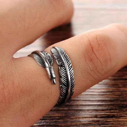 Silver stainless steel feather ring by Glitters, showcasing detailed feather design and smooth metallic finish.