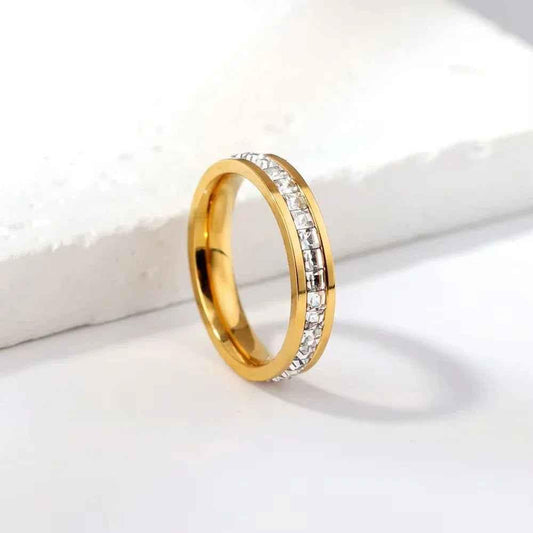 Gold stainless steel square CZ pave band ring by Glitters, showcasing a sleek modern design with sparkling cubic zirconia accents.