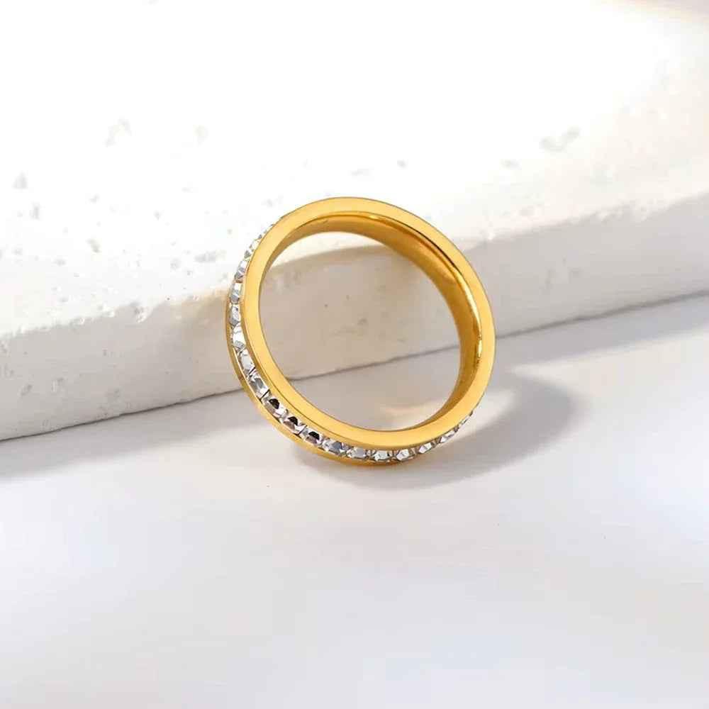 Gold stainless steel square CZ paved band ring by Glitters, showcasing a sleek geometric design with sparkling stones.