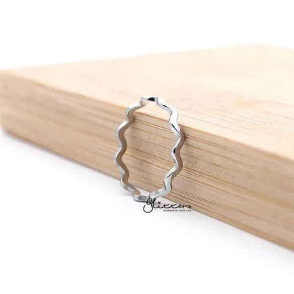 Silver stainless steel wavy women's ring from Glitters, showcasing a sleek, shiny design with a modern, elegant wave pattern.