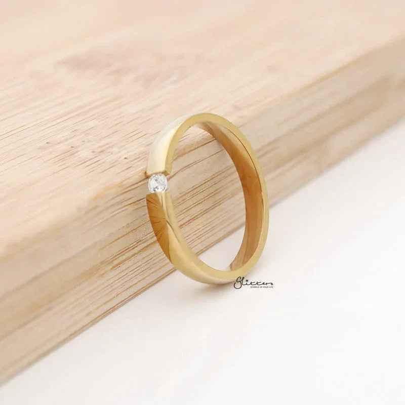 Gold stainless steel Tension Set CZ band ring with 3mm width, glossy mirror polish, from Glitters.