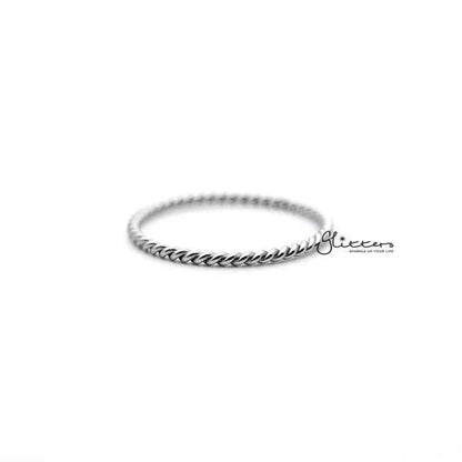 Twisted stainless steel women's ring in silver, showcasing smooth, intertwined design from Glitters.