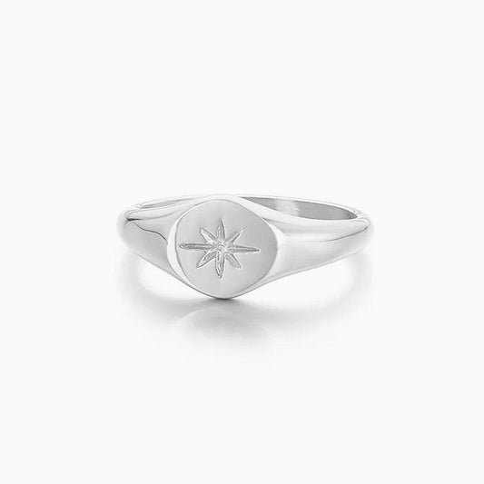 Silver stainless steel oval sunburst signet ring from Glitters, showcasing a polished, detailed design on a sleek band.