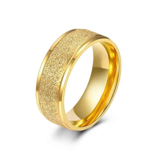 Stainless steel band ring with a gold sandblasted finish, 8mm width, from Glitters, showcasing its textured surface and sleek design.