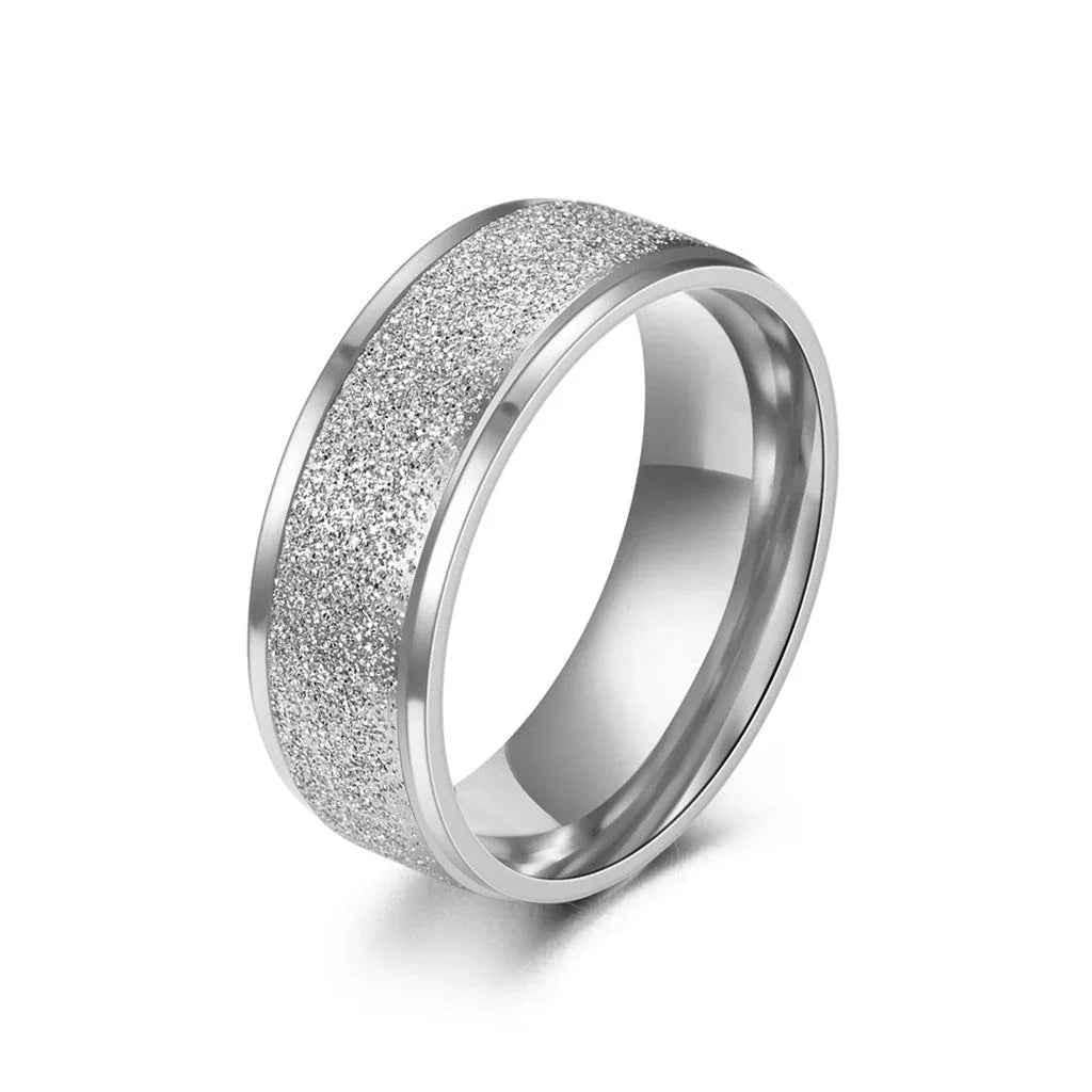 Silver stainless steel ring with sandblasted finish, 8mm band, from Glitters, showcasing its textured surface and sleek design.